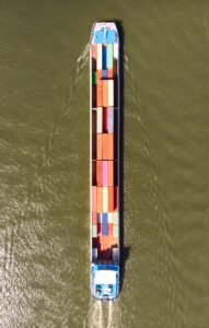 a large boat with a lot of colorful containers on it