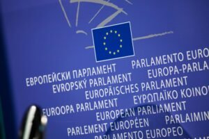 Close-up view of the European Union flag with multilingual text showing European Parliament.